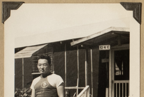Roy Sugino outside a barrack (ddr-densho-542-518)