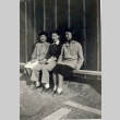 Three women sitting outside a barracks (ddr-densho-339-17)
