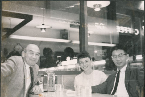 Chester Sakura Sr., with man and woman at a cafe (ddr-densho-523-336)