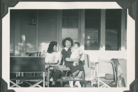 Two friends and a baby sitting on a front porch (ddr-densho-328-71)