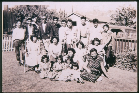 Group of people seated and standing on grass (ddr-densho-330-212)