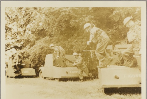 Soldiers jumping off the back of small armored trucks (ddr-njpa-13-1494)