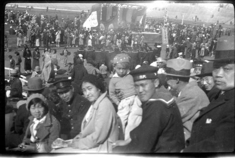 Family in stands at Kezar stadium with large crowd (ddr-densho-426-1574)