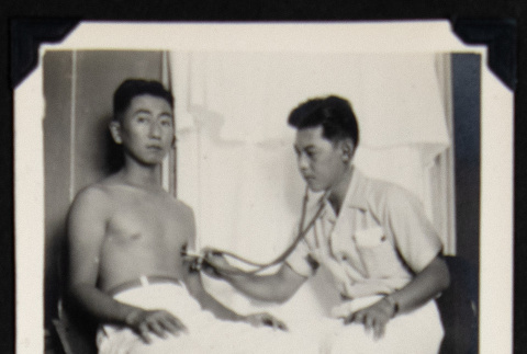 Man getting a medical examination (ddr-densho-542-746)