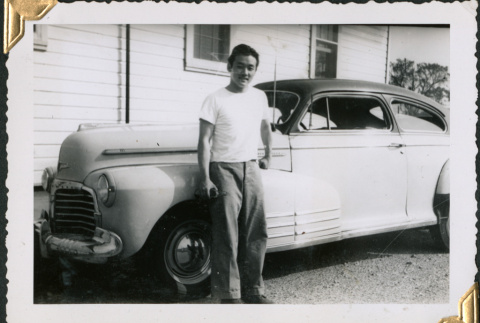 Man standing by car (ddr-densho-434-252)