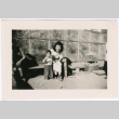 Women Sitting with Child outside barracks (ddr-densho-329-1362)
