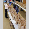 Women filling food bags at long tables (ddr-densho-512-98)