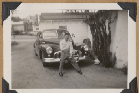 Man leaning on a bumper (ddr-densho-542-155)