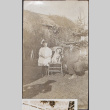 Man and girl, with dog sitting on chair (ddr-densho-493-170)