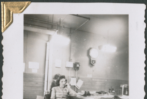 Woman sitting at a desk on the phone (ddr-densho-434-243)