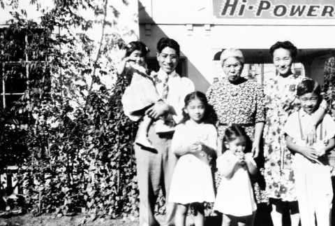 Family standing outside a gas station (ddr-densho-5-18)