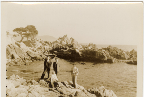 Tomoye (Nozawa) Takahashi and three men on rocky shore (ddr-densho-426-1782)