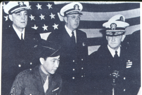 Four in front of flag (ddr-densho-1007-1337)