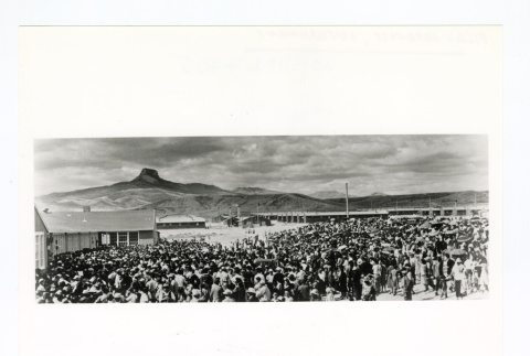 Large crowd of people are gathered outside at an incarceration camp (ddr-csujad-52-42)