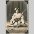 Portrait of girl dressed in kimono with instrument (ddr-densho-383-236)