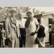 Victor S. K. Houston and wife wearing leis, posing with another man (ddr-njpa-2-432)