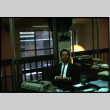 Henri Takahashi seated in office (ddr-densho-426-314)