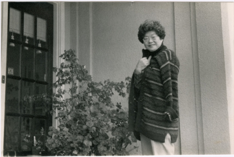 Tomoye Takahashi in doorway of house (ddr-densho-426-1125)