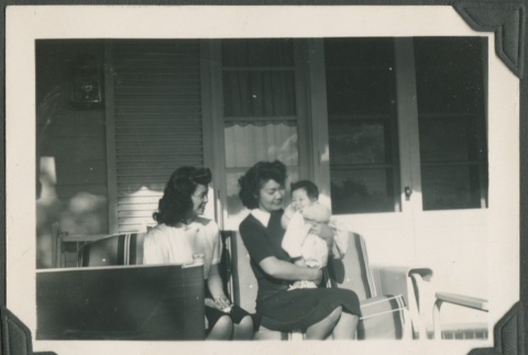 Two friends and a baby sitting on a front porch (ddr-densho-328-69)