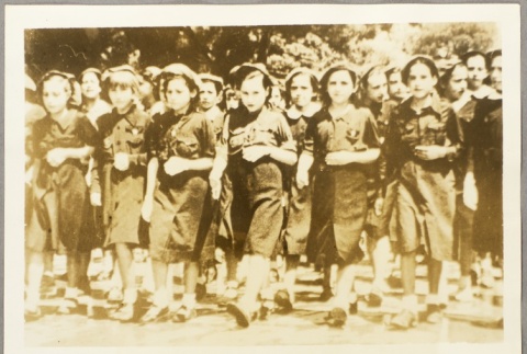Photos of a group of girls, and boys carrying toy rifles (ddr-njpa-13-634)