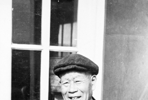 Japanese American in front of a barrack (ddr-densho-15-56)
