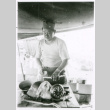 Soldier at table with clock (ddr-densho-1007-760)
