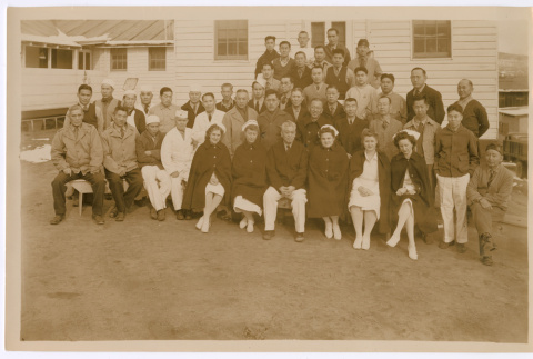 Group photo in front of medical facility with signatures on the back (ddr-densho-515-2)