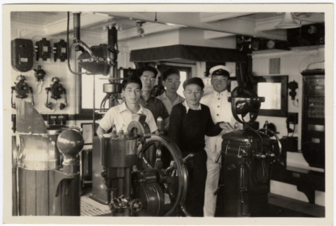Group of men and crew in wheelhouse of ship (ddr-densho-426-874)