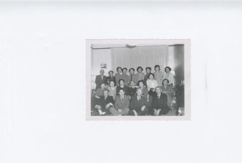 (Photograph) - Image of men and women seated and standing in room (Front) (ddr-densho-330-292-master-127e4da810)