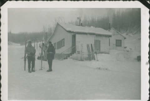 Men with skis standing outside a house (ddr-densho-321-345)