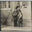 Children holding presents in front of house (ddr-densho-523-169)