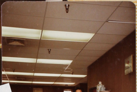 Man standing by filing cabinets (ddr-densho-426-1273)