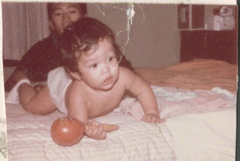 Baby with rattle (ddr-densho-523-404)