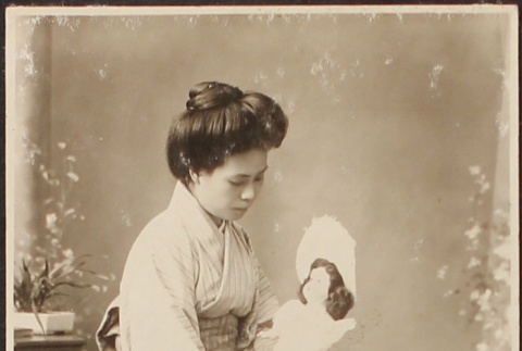 Portrait of Japanese woman in kimono with doll (ddr-densho-259-64)
