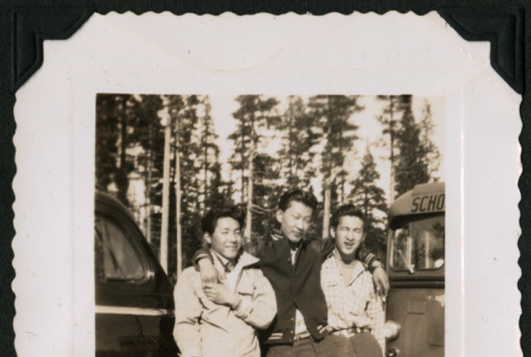 Walter Matsuoka and two companions lean against a car (ddr-densho-390-69)