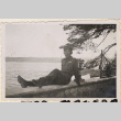 Man sitting on wall with lake in background (ddr-densho-466-354)