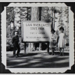 Three children standing next to the Lava River Caves State Park sign (ddr-densho-300-586)