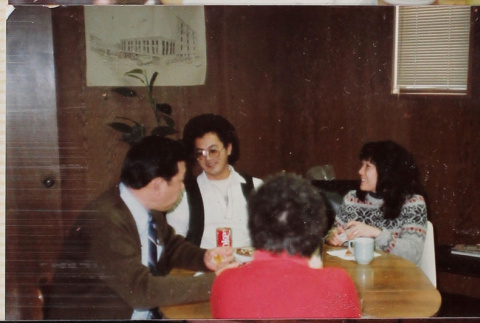 Four people at a table (ddr-densho-426-1289)