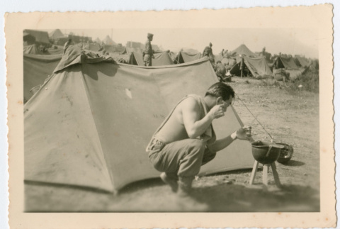 Soldier shaving in front of tent (ddr-densho-368-139)