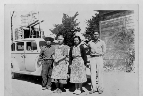 Four figures with car (ddr-densho-1007-55)