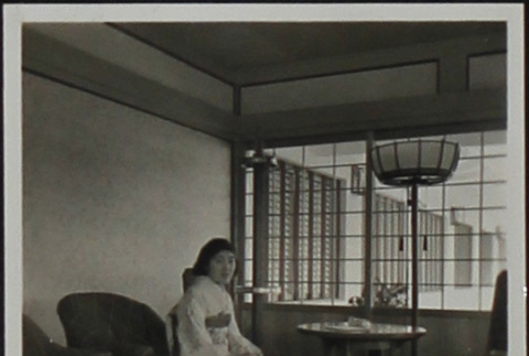 A woman seated in the Travel Room at the Golden Gate International Exposition (ddr-densho-300-384)