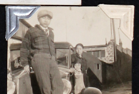Family poses on a car (ddr-densho-404-99)