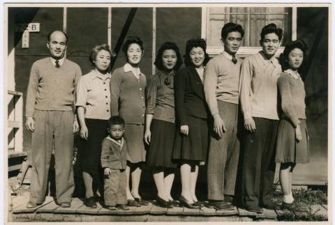 Sumida family portrait in front of barracks at Rohwer Relocation Center (ddr-densho-379-399)
