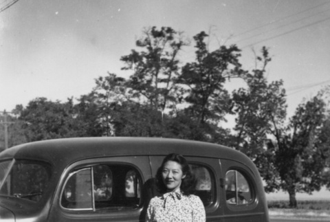 Mitsue Ozeki standing by car (ddr-ajah-6-846)