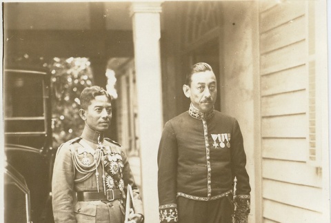 Two men in uniform standing near a car (ddr-njpa-1-2248)