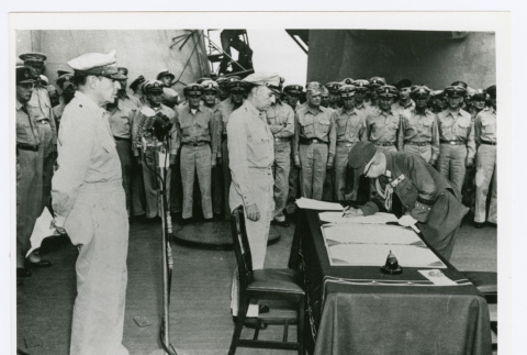 General Yoshijiro Umezu signing at surrender ceremonies aboard Battleship Missouri in Tokyo Bay (ddr-densho-1007-88)