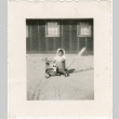 Baby girl in a stroller in front of barracks (ddr-densho-350-23)