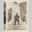 Man sitting at base of memorial (ddr-densho-466-306)
