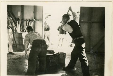 Pounding steamed rice at camp (ddr-densho-37-1311)
