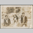 Two men and a woman sitting on logs (ddr-densho-316-304)